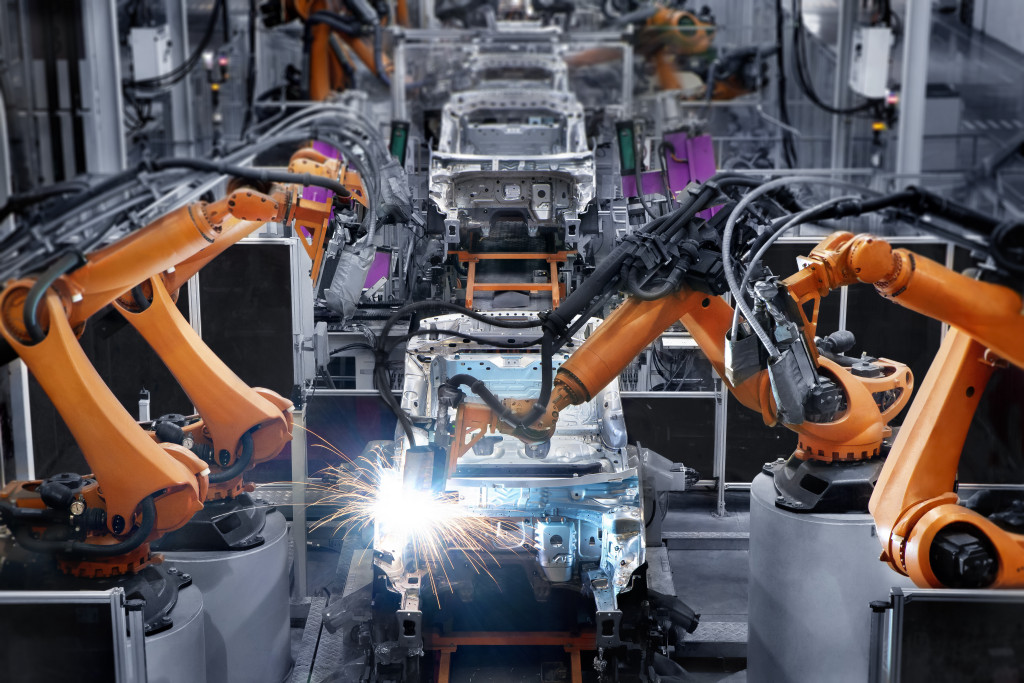 Robotic arms in a car manufacturing place